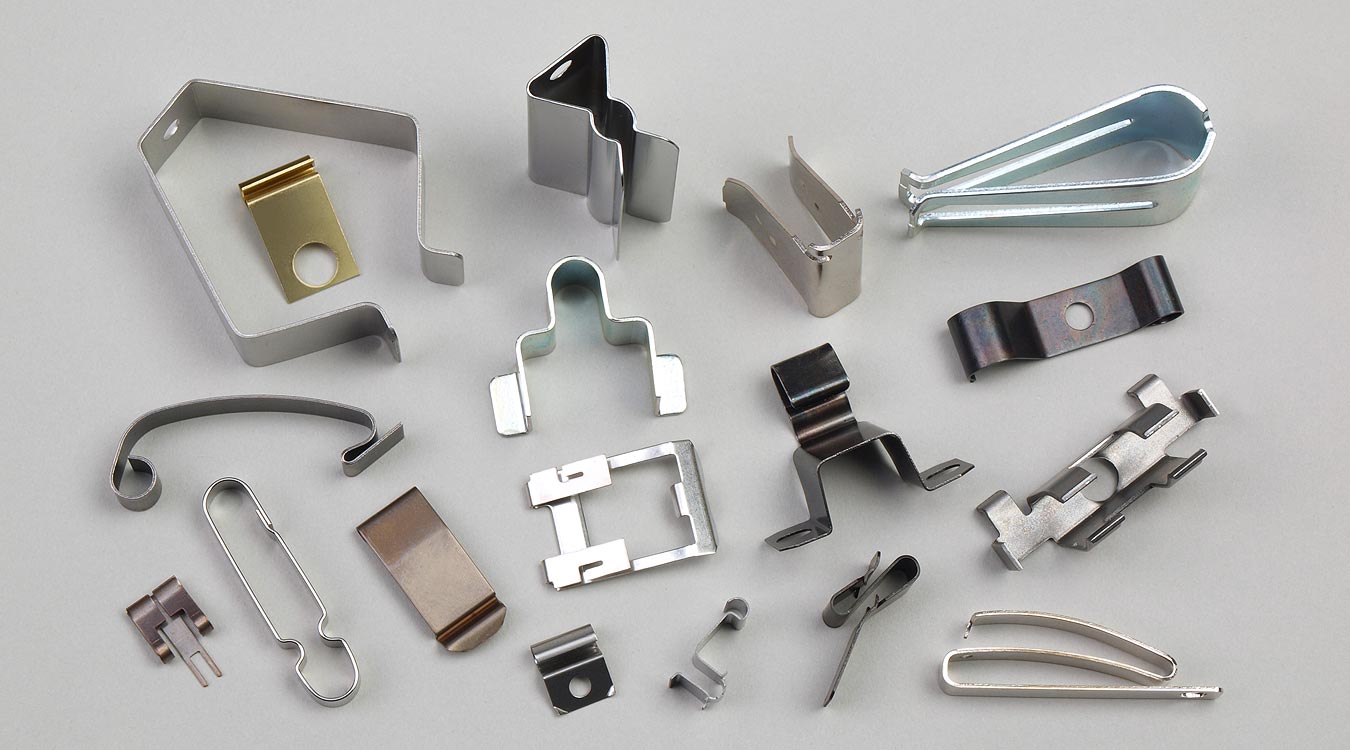 Multi-Feature Stainless Clips: 0.8 mm SS304, compound die with simultaneous pierce + form, spring-temper hardness HRC 28–32. Variety of geometries in one run.